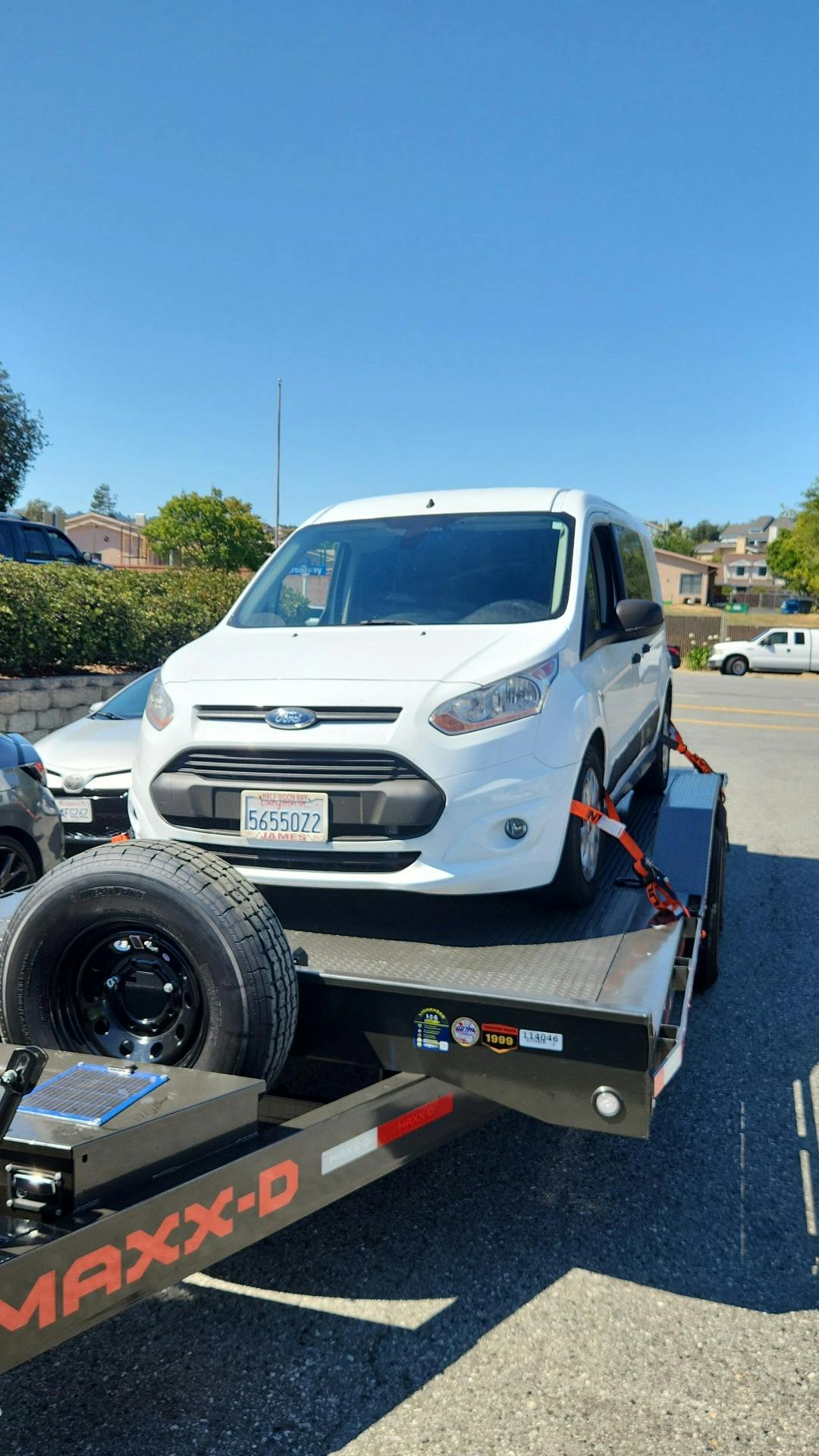 Ford sedan being towed by Mike's Tow and Transport LLC