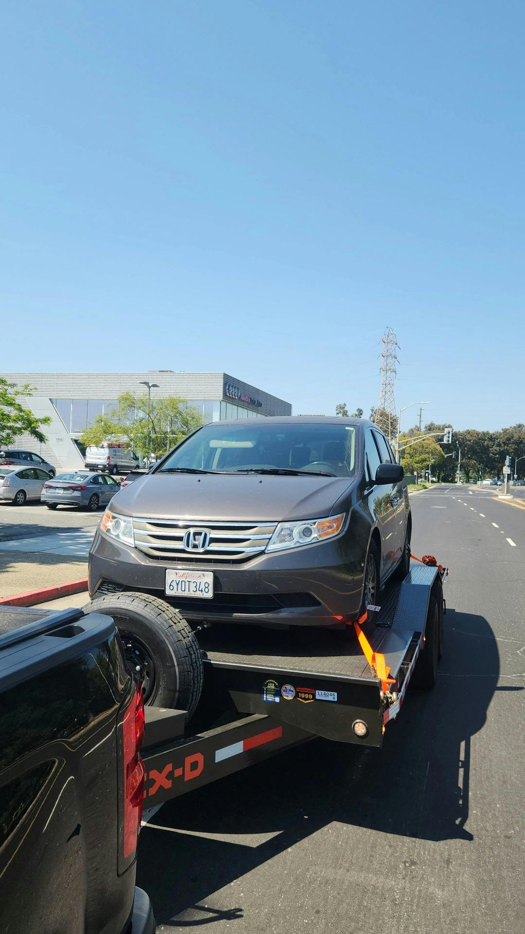 Honda sedan being towed by Mike's Tow and Transport LLC