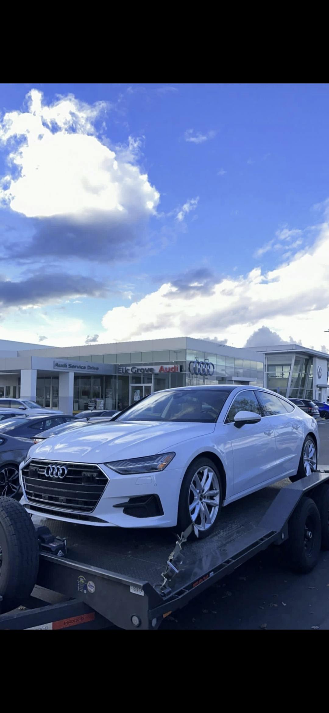 Audi sedan being towed by Mike's Tow and Transport LLC