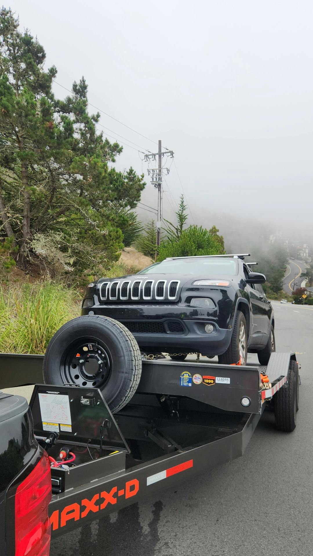 Jeep being towed by Mike's Tow and Transport LLC