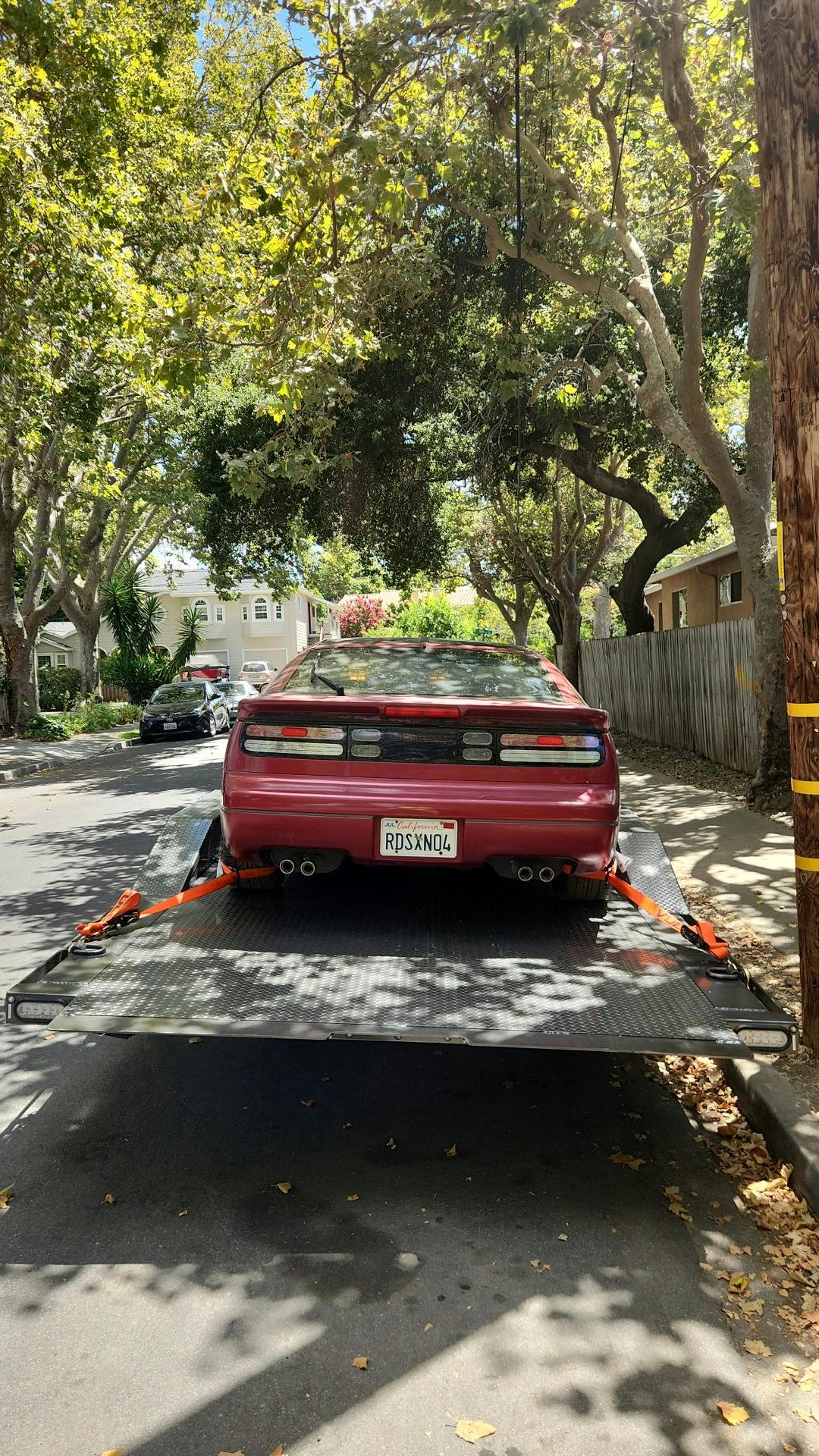 Red sports car being towed by Mike's Tow and Transport LLC